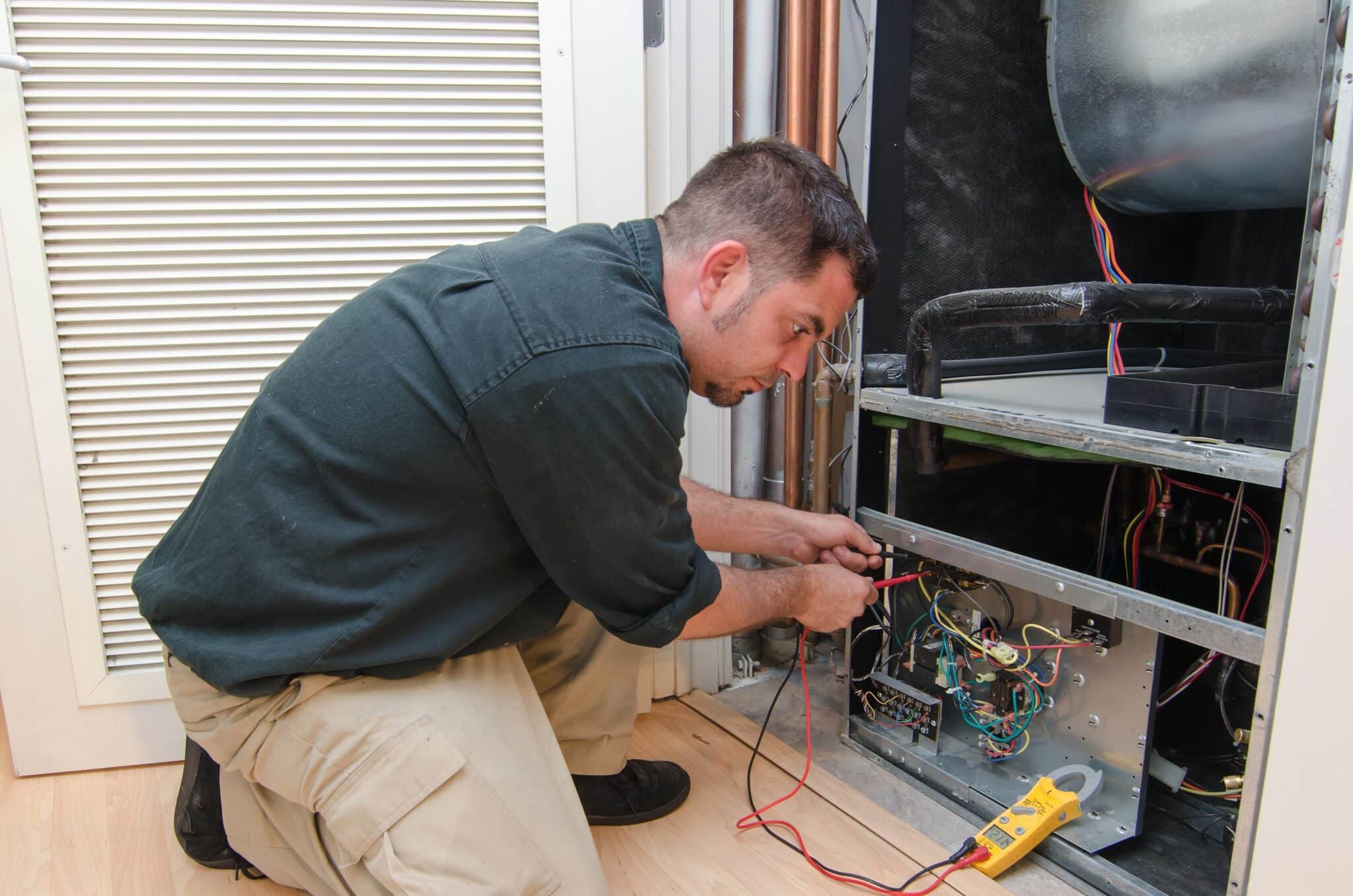 HVAC technician working on a residential heat pumps.